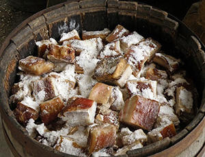 salting meat in a barrel
