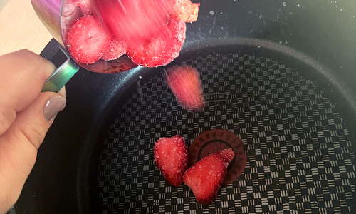Adding berries o a sauce pan