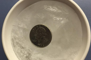 Why You Should Put A Coin In A Cup Of Frozen Water In Your Freezer