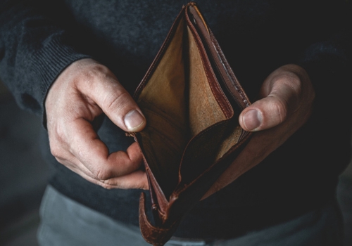 Man holding an empty wallet